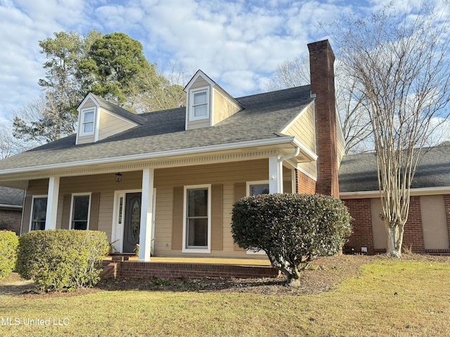 cape cod home featuring covered porch and a front lawn