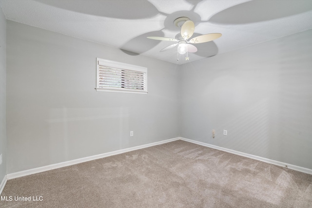 spare room featuring carpet and ceiling fan