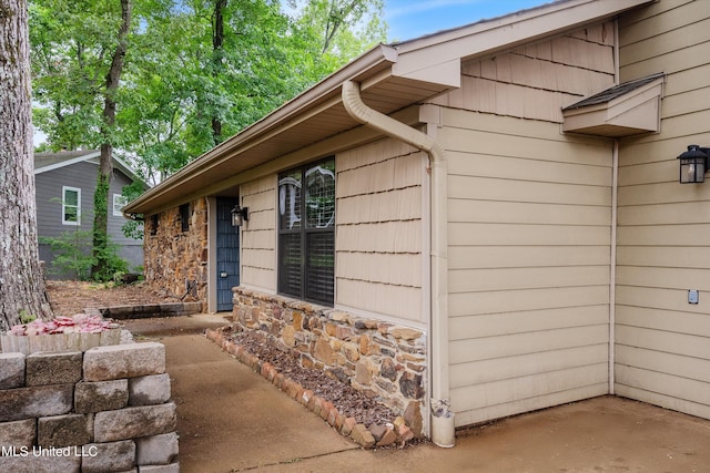 view of property exterior with a patio