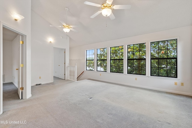 carpeted spare room with high vaulted ceiling and ceiling fan