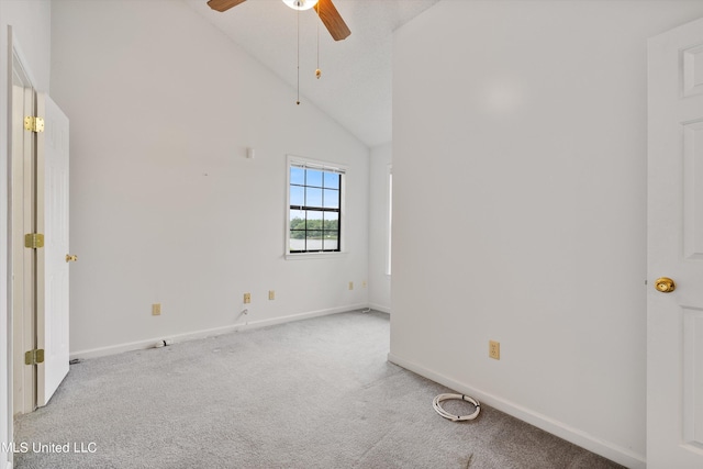 carpeted spare room featuring high vaulted ceiling and ceiling fan