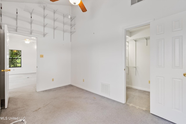 unfurnished room with light colored carpet and ceiling fan