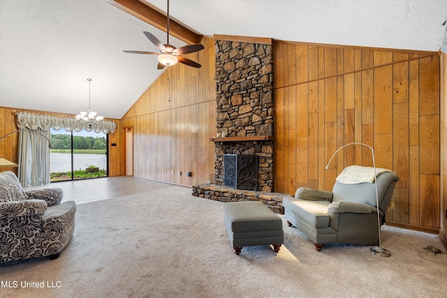 living room with carpet flooring, beam ceiling, and wood walls