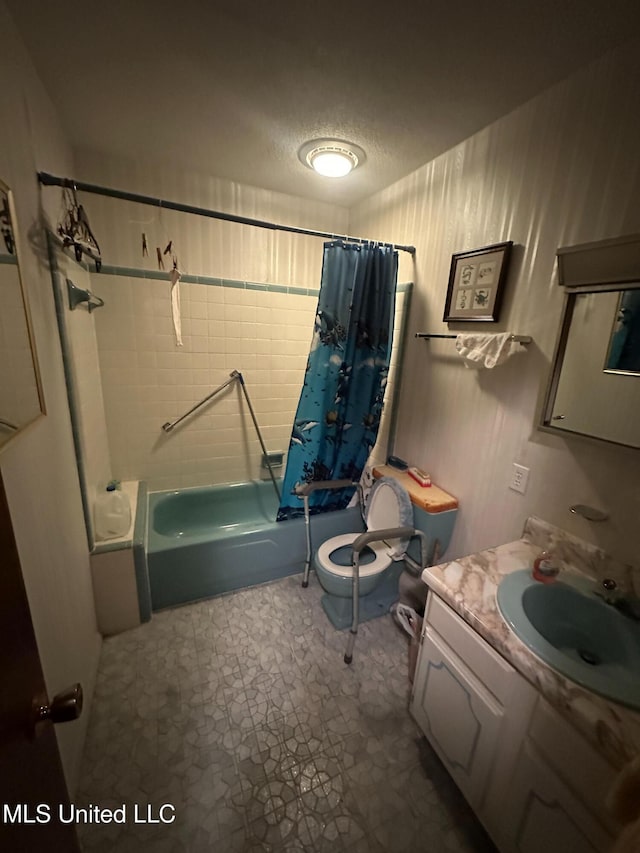 full bath featuring toilet, a textured ceiling, vanity, and shower / tub combo with curtain