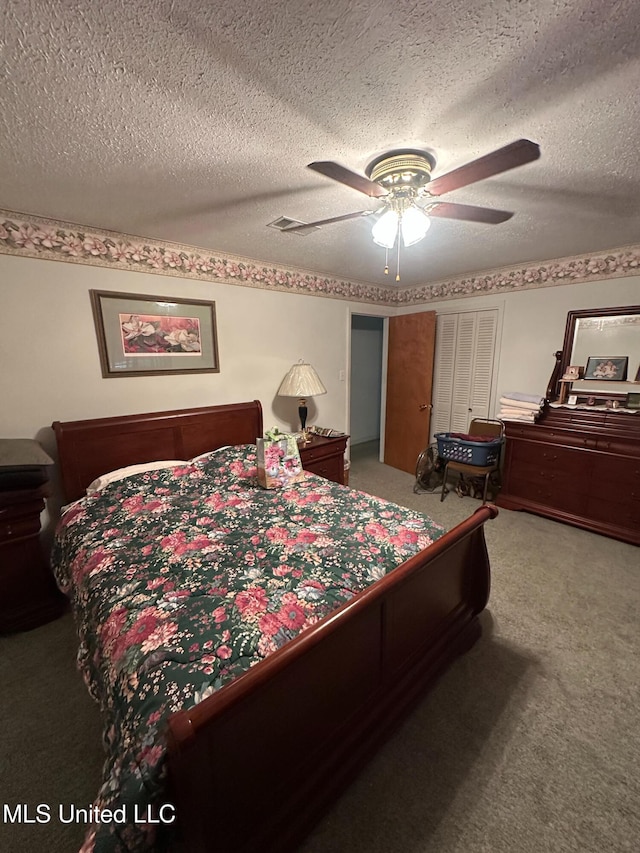 bedroom featuring a textured ceiling, ceiling fan, and carpet floors