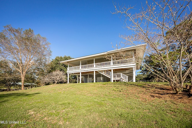 back of house featuring a yard and a deck