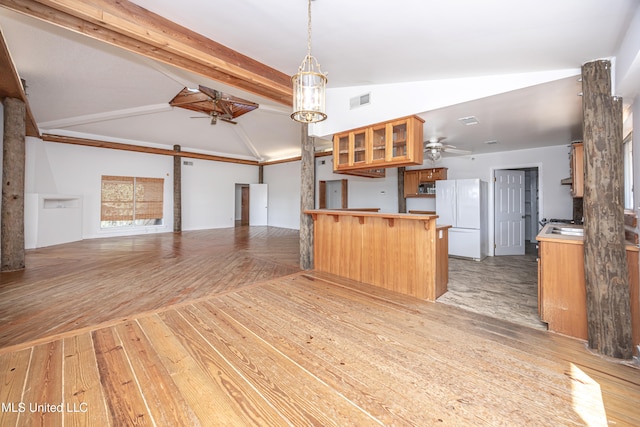 kitchen with ceiling fan, lofted ceiling with beams, white refrigerator, kitchen peninsula, and light hardwood / wood-style floors