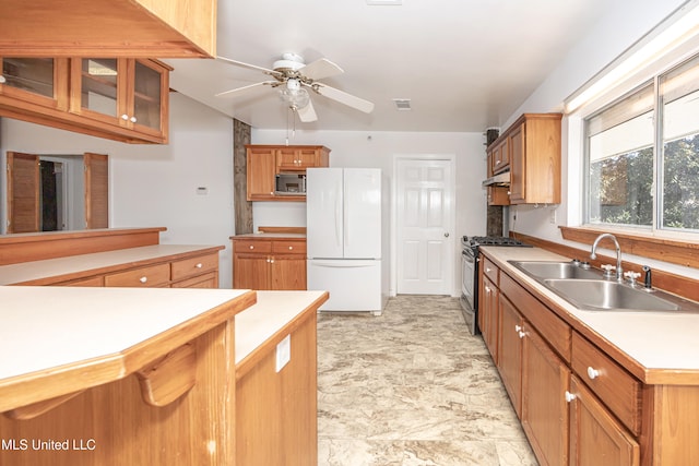 kitchen with ceiling fan, sink, and appliances with stainless steel finishes