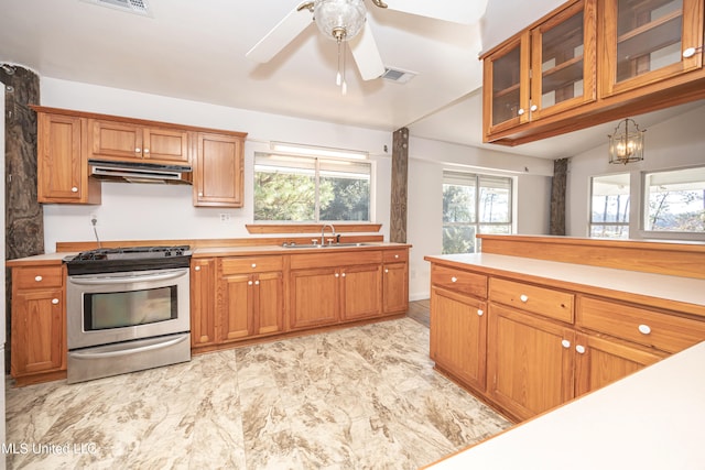 kitchen with ceiling fan, stainless steel range, and sink