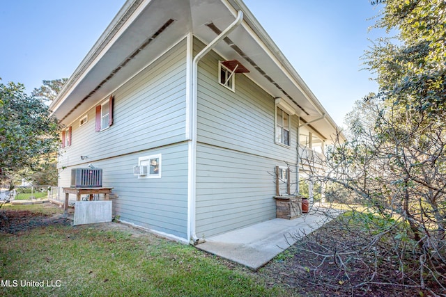 view of property exterior with central AC and a patio