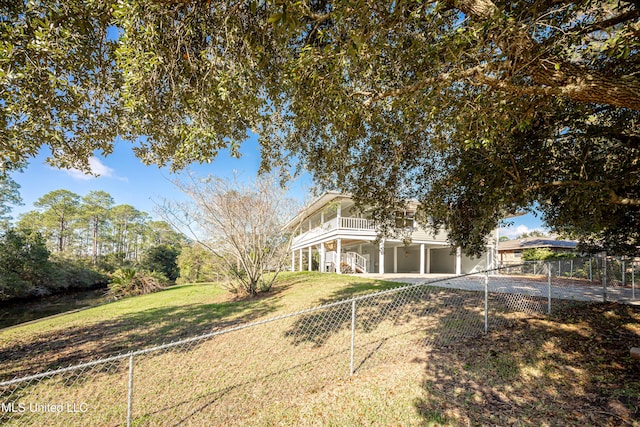 view of front of home featuring a balcony and a front yard