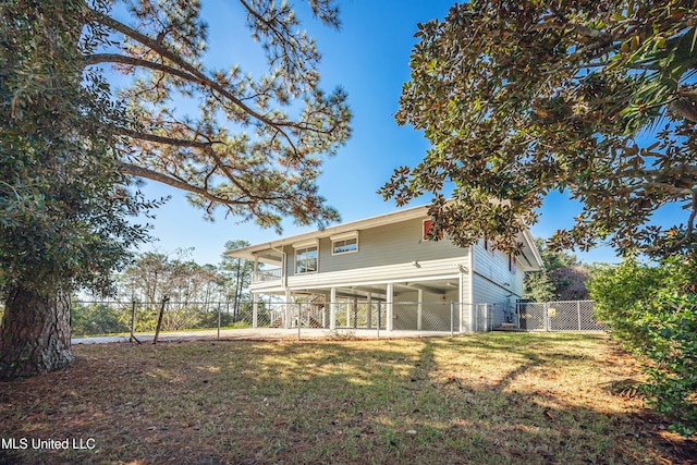 rear view of house with a yard