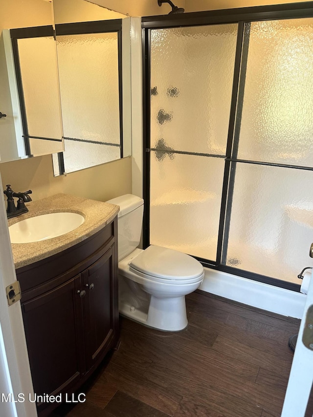 19728 Hwy 63, Moss Point, MS 39562 - bathroom featuring vanity, a stall shower, toilet, and wood finished floors