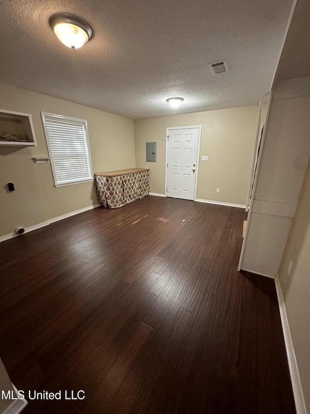 19728 Hwy 63, Moss Point, MS 39562 - unfurnished room featuring dark wood finished floors, a textured ceiling, electric panel, and baseboards
