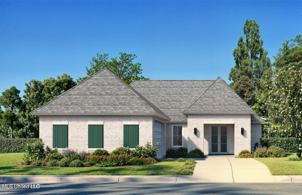 10875 Lily Ln, Gulfport, MS 39503 - view of front facade with french doors, brick siding, a front lawn, and a shingled roof