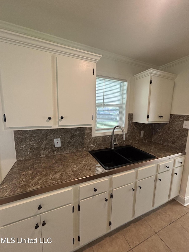 230 Greenbriar Cir, Holly Springs, MS 38635 - kitchen with a sink, white cabinets, crown molding, decorative backsplash, and light tile patterned floors