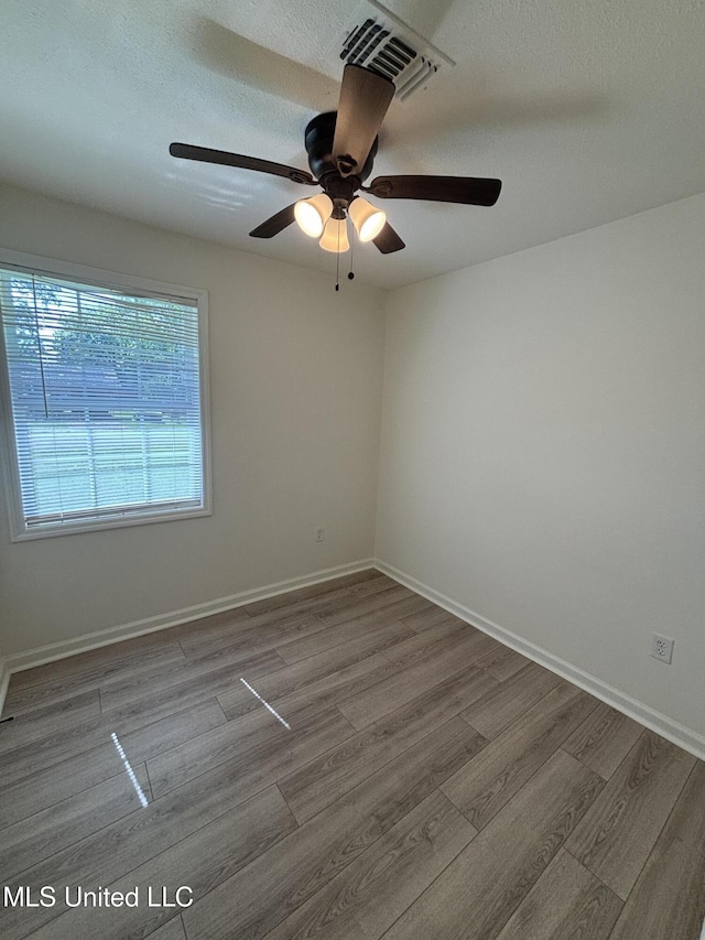 230 Greenbriar Cir, Holly Springs, MS 38635 - empty room featuring wood finished floors, ceiling fan, a textured ceiling, and baseboards