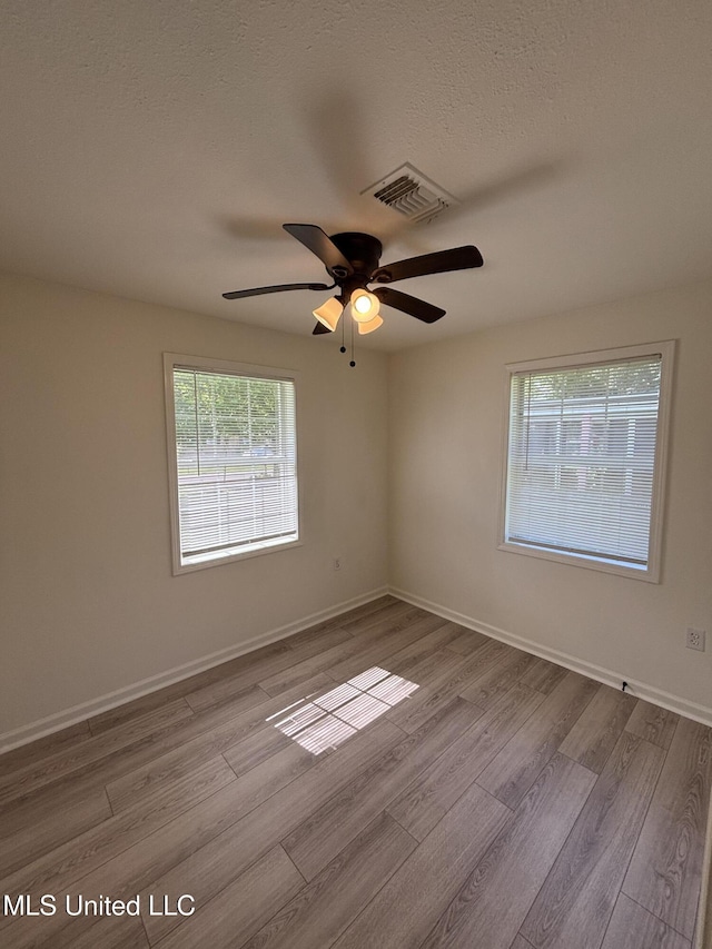 230 Greenbriar Cir, Holly Springs, MS 38635 - spare room with wood finished floors, a ceiling fan, and baseboards