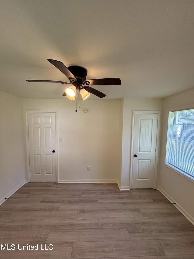 230 Greenbriar Cir, Holly Springs, MS 38635 - spare room featuring a ceiling fan, wood finished floors, and baseboards