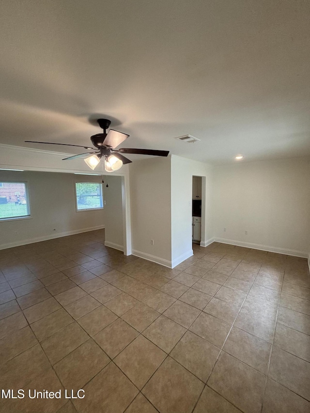 230 Greenbriar Cir, Holly Springs, MS 38635 - unfurnished room with light tile patterned floors, a ceiling fan, and baseboards