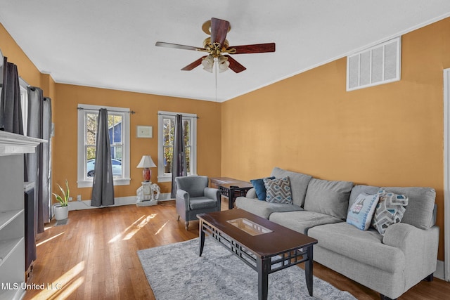 living room featuring ceiling fan and hardwood / wood-style floors