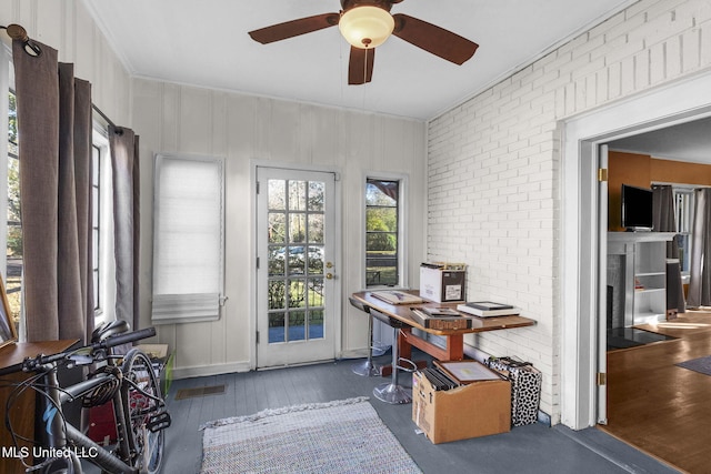 sunroom featuring ceiling fan