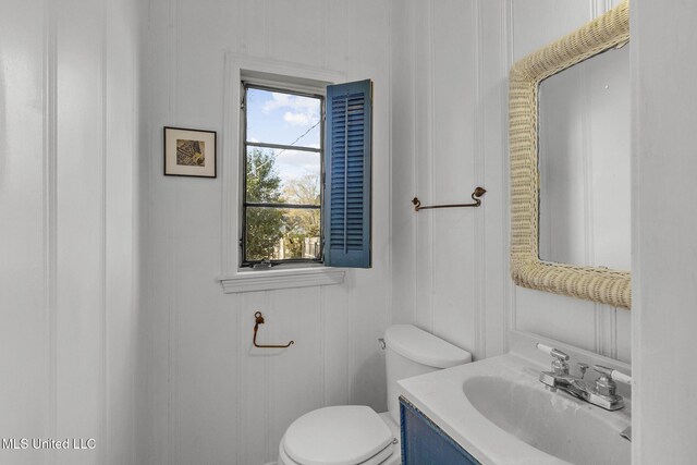 bathroom with vanity, a healthy amount of sunlight, and toilet