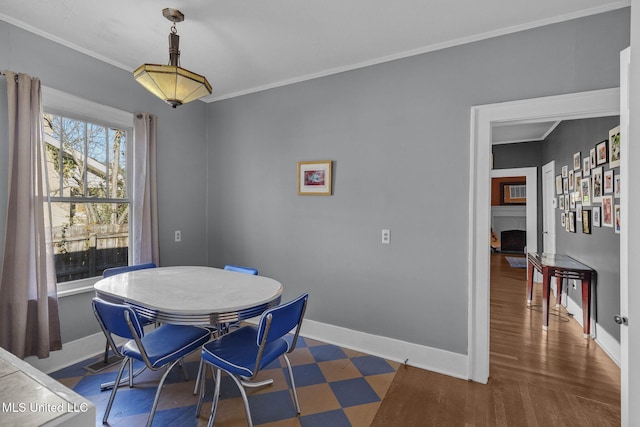 dining space featuring dark wood-type flooring and ornamental molding