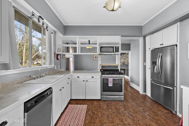 kitchen featuring crown molding, sink, white cabinets, and appliances with stainless steel finishes