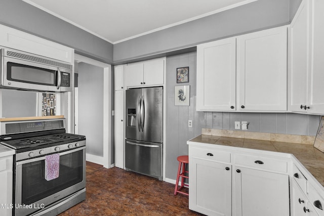 kitchen featuring white cabinetry and appliances with stainless steel finishes