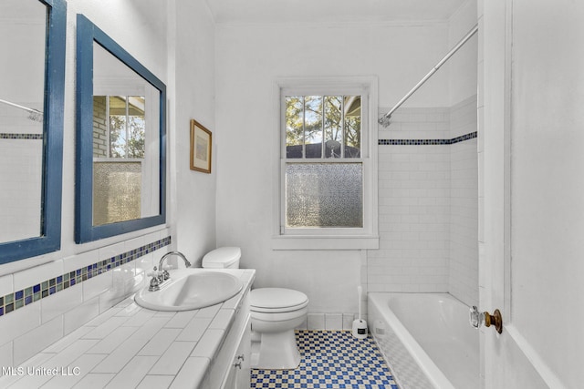 full bathroom featuring vanity, toilet, and tiled shower / bath combo