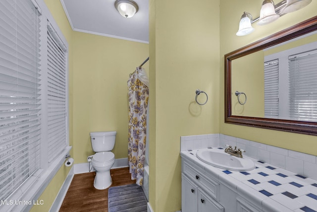 full bathroom with crown molding, shower / bath combination with curtain, toilet, vanity, and hardwood / wood-style flooring