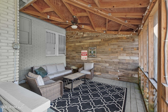 interior space with brick wall, ceiling fan, wood-type flooring, vaulted ceiling with beams, and wood walls