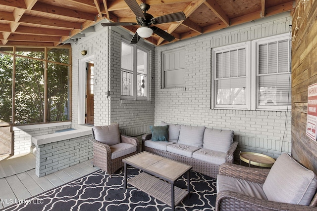 sunroom featuring beamed ceiling and ceiling fan