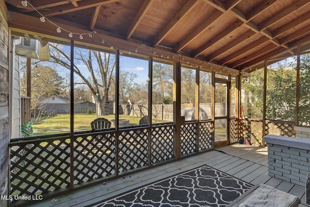 unfurnished sunroom featuring lofted ceiling