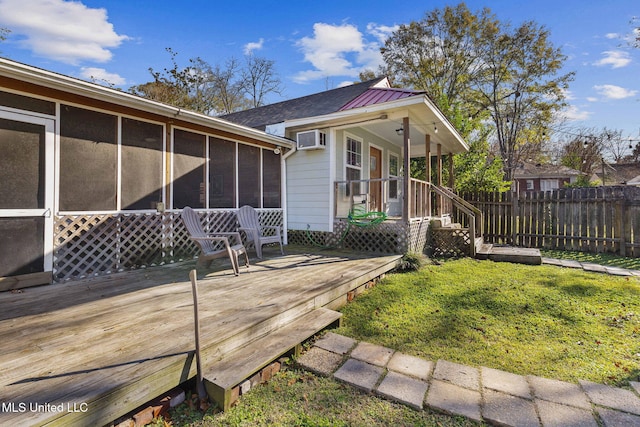 exterior space with a yard, a wall mounted AC, and a sunroom