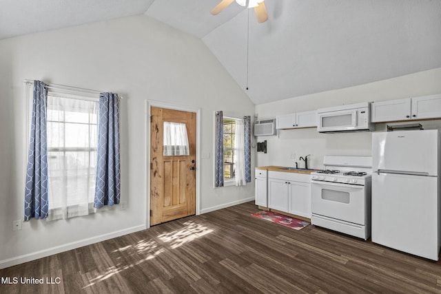 kitchen featuring dark hardwood / wood-style flooring, white appliances, a wall unit AC, ceiling fan, and white cabinets