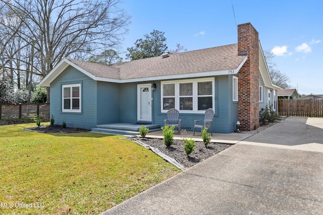 single story home with roof with shingles, a front lawn, a chimney, and fence