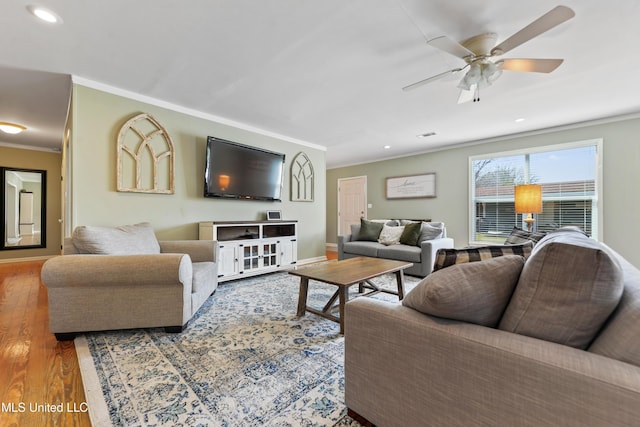 living room with ornamental molding, wood finished floors, a ceiling fan, and recessed lighting