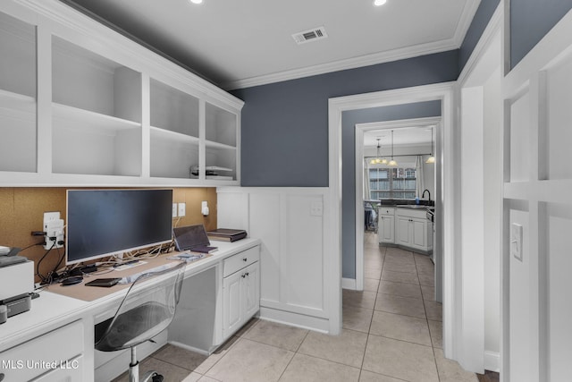 101 Marion Dr, Clinton, MS 39056 - office area featuring a sink, ornamental molding, light tile patterned flooring, built in desk, and a wainscoted wall