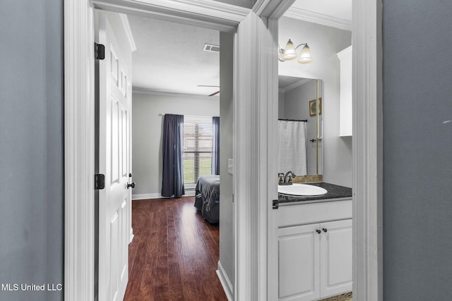 101 Marion Dr, Clinton, MS 39056 - ensuite bathroom with ornamental molding, wood finished floors, vanity, baseboards, and curtained shower