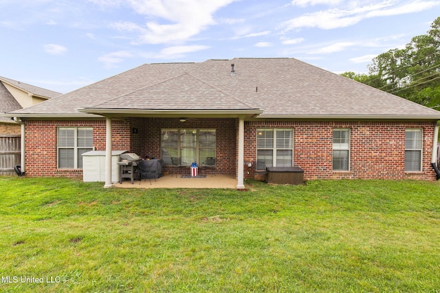 101 Marion Dr, Clinton, MS 39056 - back of house featuring a shingled roof, a patio, brick siding, and a lawn