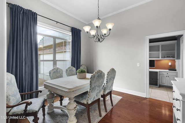 101 Marion Dr, Clinton, MS 39056 - dining area with a chandelier, crown molding, light wood-style floors, and baseboards