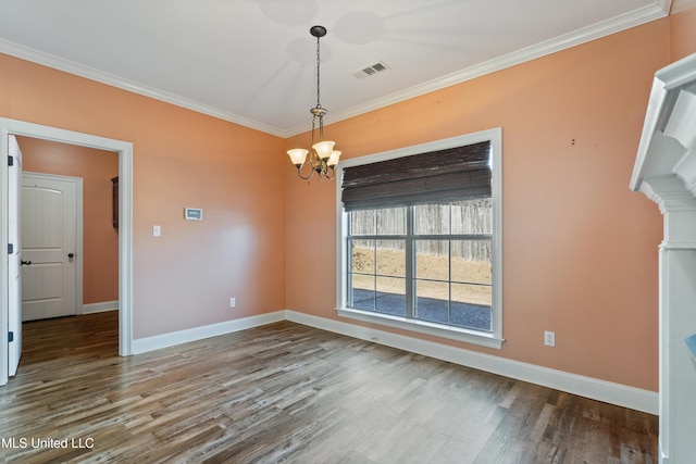 unfurnished room featuring crown molding, wood-type flooring, and an inviting chandelier