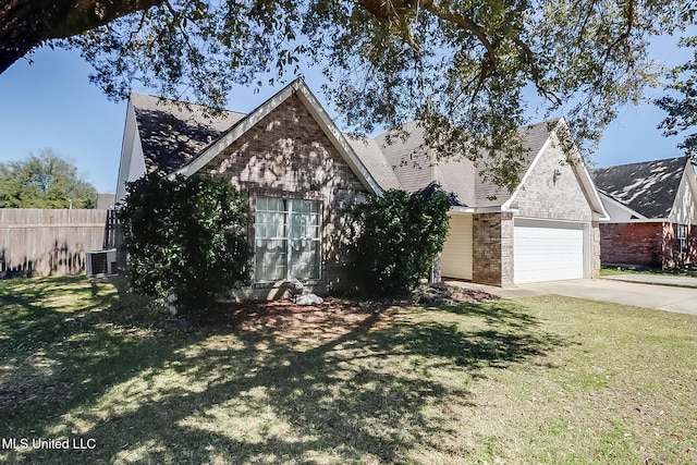 view of front of property featuring an attached garage, central AC, brick siding, fence, and a front lawn