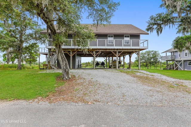 beach home with a carport and a front lawn