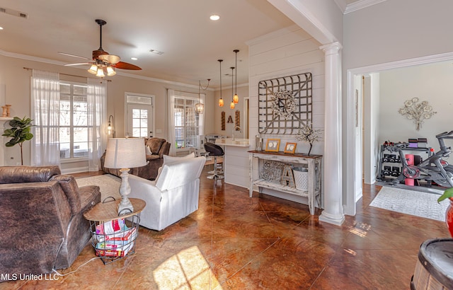 living room with ornate columns, crown molding, and ceiling fan