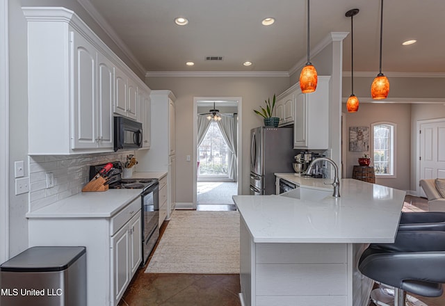 kitchen featuring sink, white cabinetry, hanging light fixtures, kitchen peninsula, and black appliances