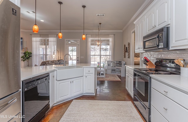 kitchen featuring sink, white cabinetry, ornamental molding, black appliances, and decorative light fixtures