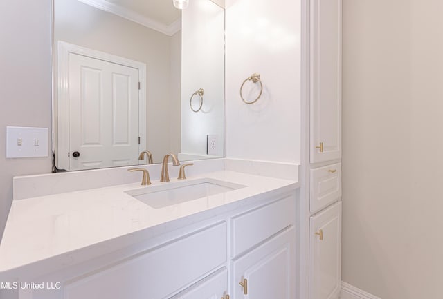 bathroom featuring ornamental molding and vanity